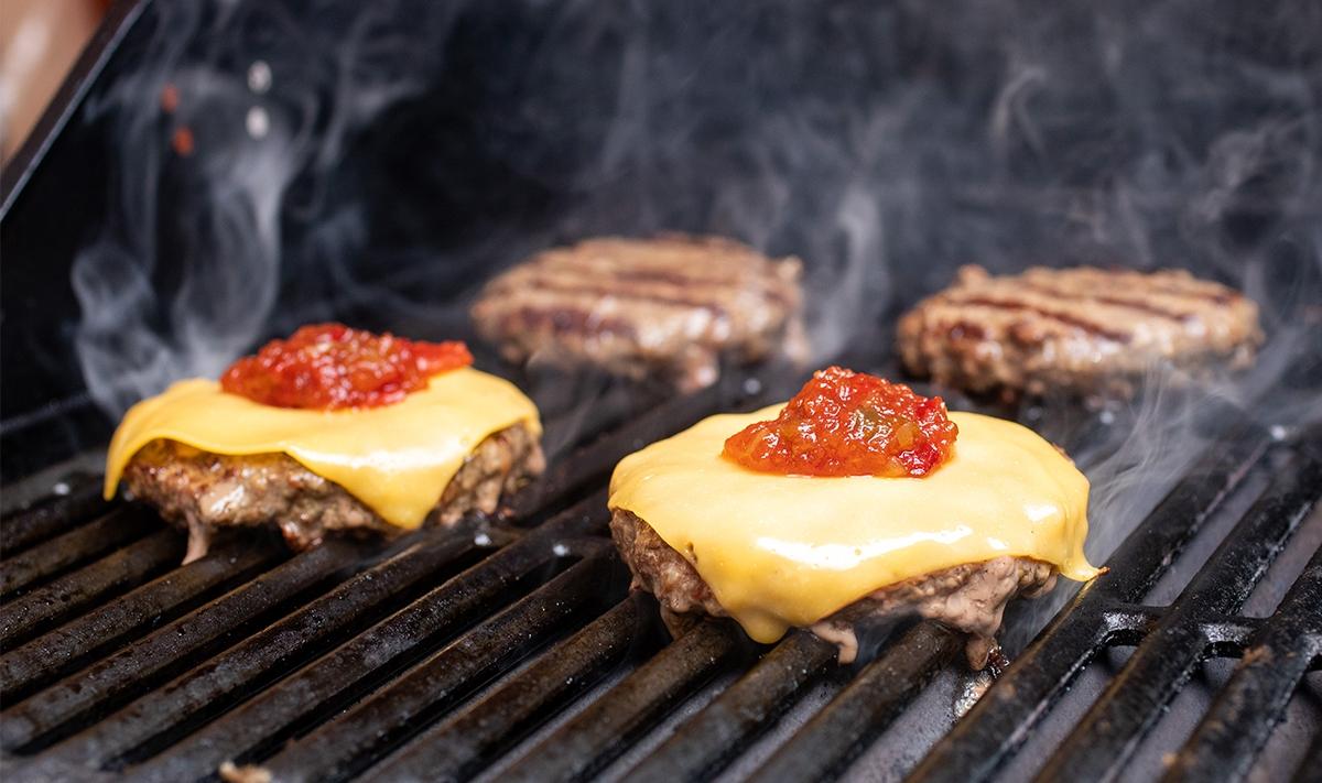 grilling burgers with cheese and relish