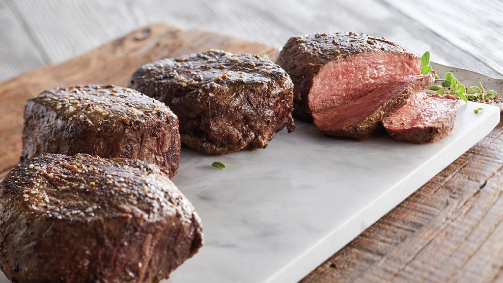 filet mignon image   four pieces of filet mignon on a white counter top