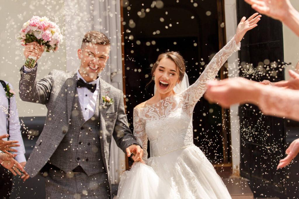 Wedding gift etiquette with a bride and groom exiting a church.