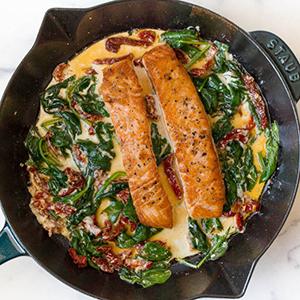 Cast iron salmon recipe with spinach cream sauce.