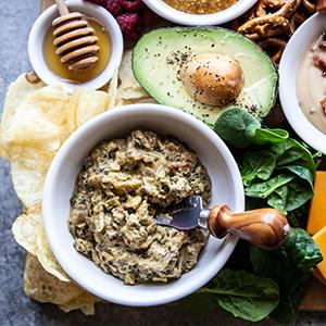 Spinach dip on a snack board.